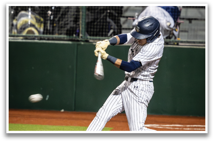 A baseball player is swinging a bat at a ball, with the ball in the air and the player's arm extended. Contenido generado con IA