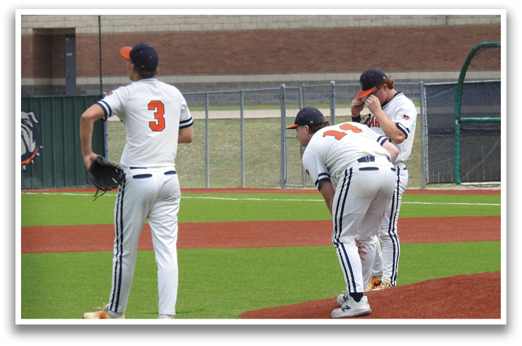 Three baseball players are standing on a field, one of them bending over. Contenido generado con IA
