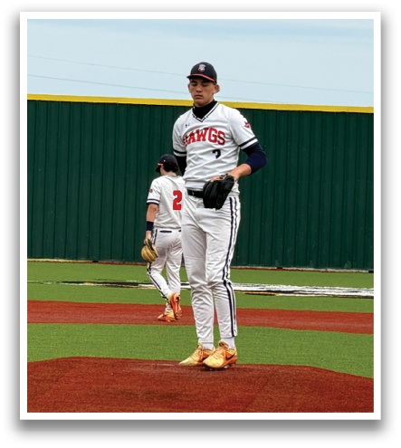 A baseball player is standing on the field, wearing a white uniform. Contenido generado con IA