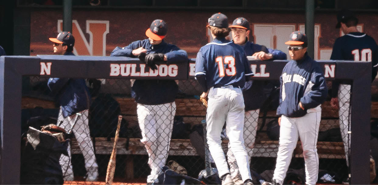A group of baseball players are standing on the field, some of them wearing blue uniforms. Contenido generado con IA
