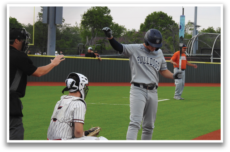 A baseball player is standing on home plate, holding his arms up in the air. Contenido generado con IA
