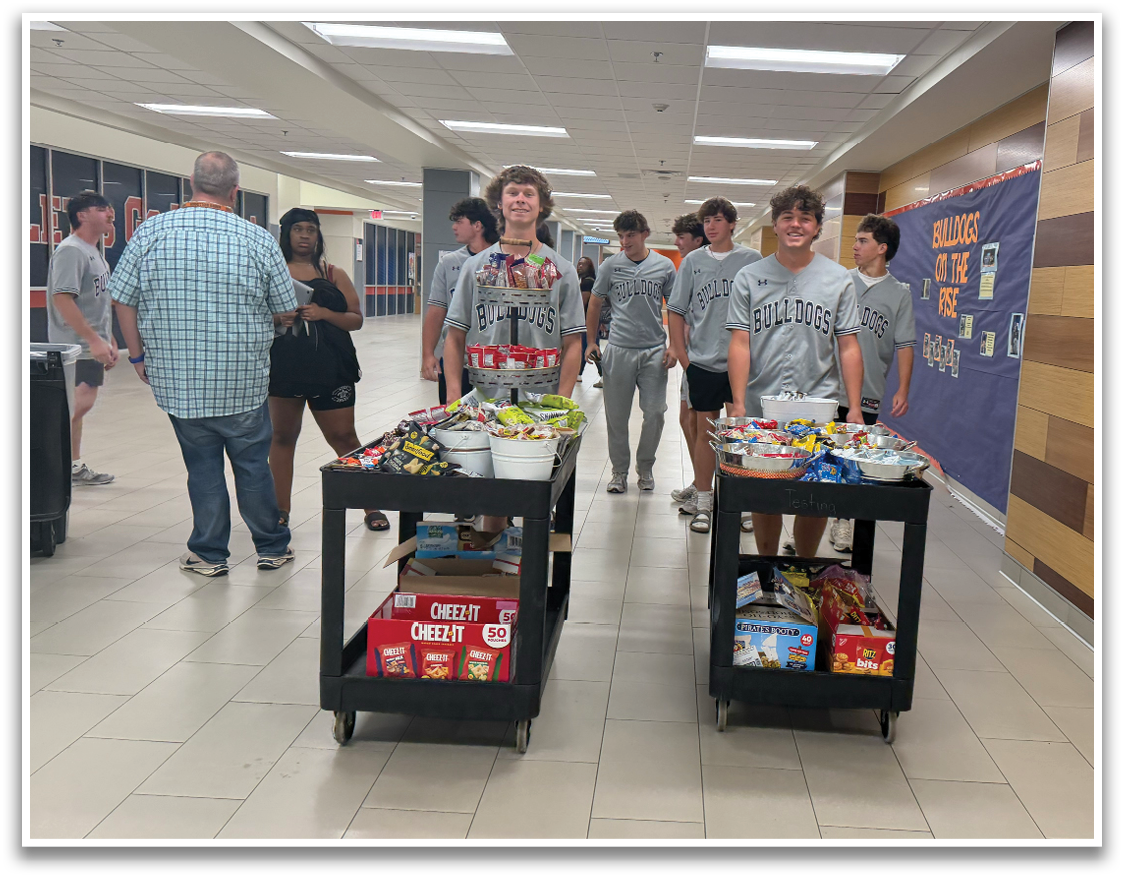 A group of young people are standing in a hallway, some of them wearing shirts that say “Golden." They are holding carts full of snacks and drinks. Contenido generado con IA