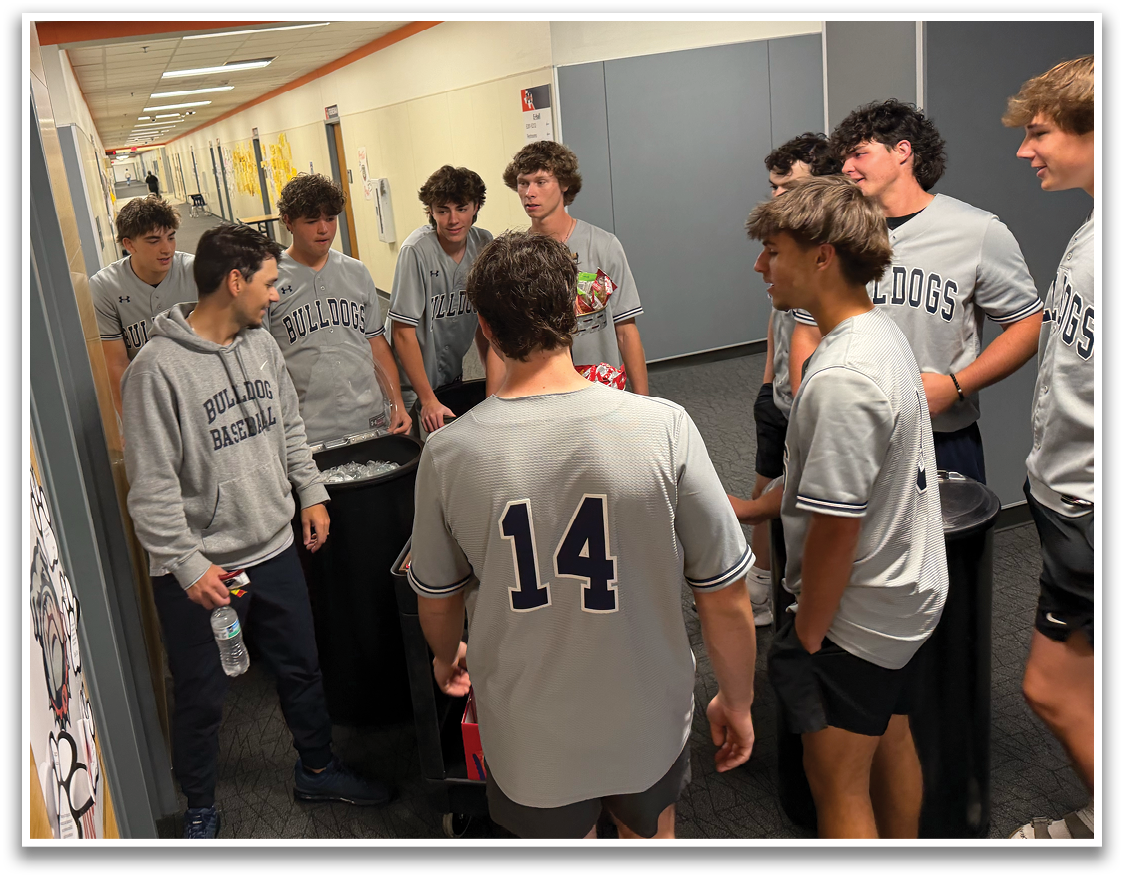 A group of young men wearing sports uniforms are gathered in a hallway. Contenido generado con IA