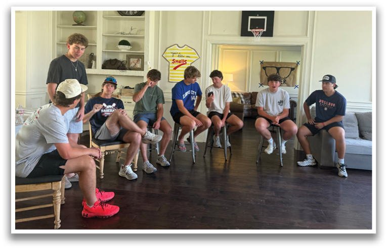 A group of young men are sitting on chairs in a living room. Contenido generado con IA