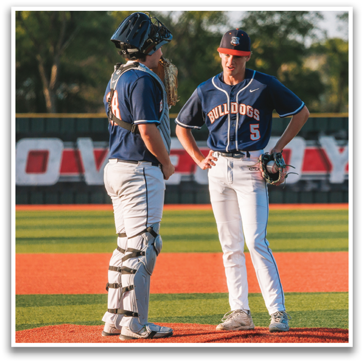 Two baseball players are standing on a field, one of them wearing a blue jersey. Contenido generado con IA