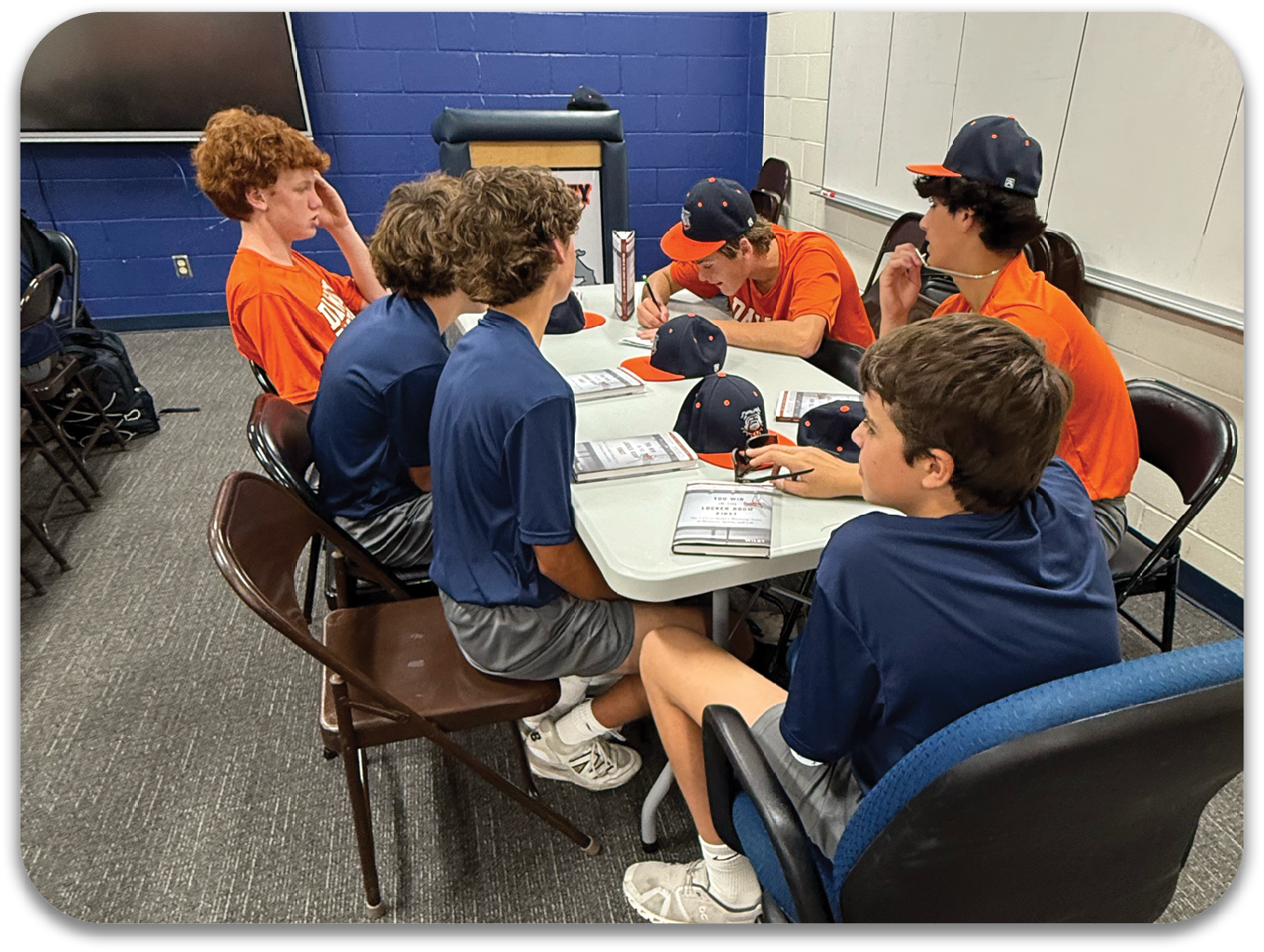 A group of people are sitting around a table in a classroom. Contenido generado con IA