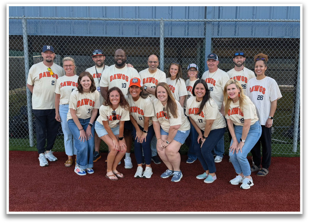 A group of people wearing orange and white shirts pose for a picture on a baseball field. Contenido generado con IA