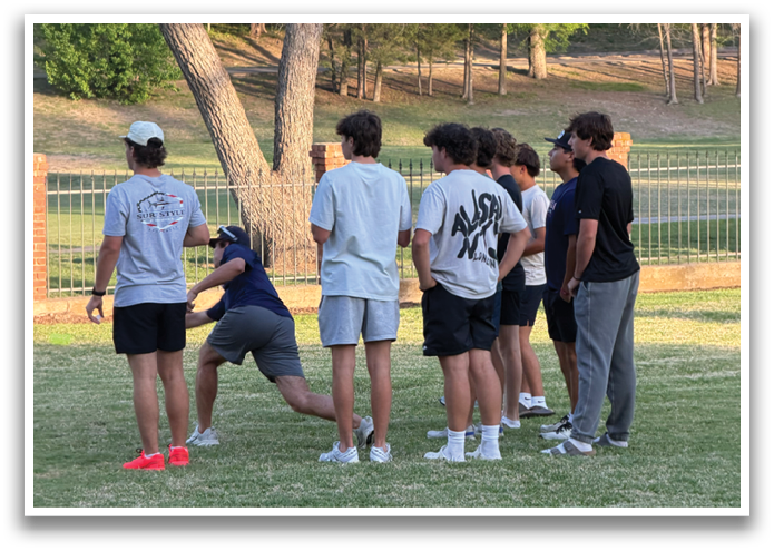 A group of people are standing in a grassy field, some of them wearing shorts. Contenido generado con IA