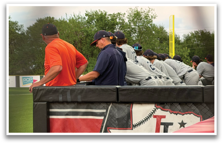A group of men are sitting on a bench, watching a baseball game. Contenido generado con IA