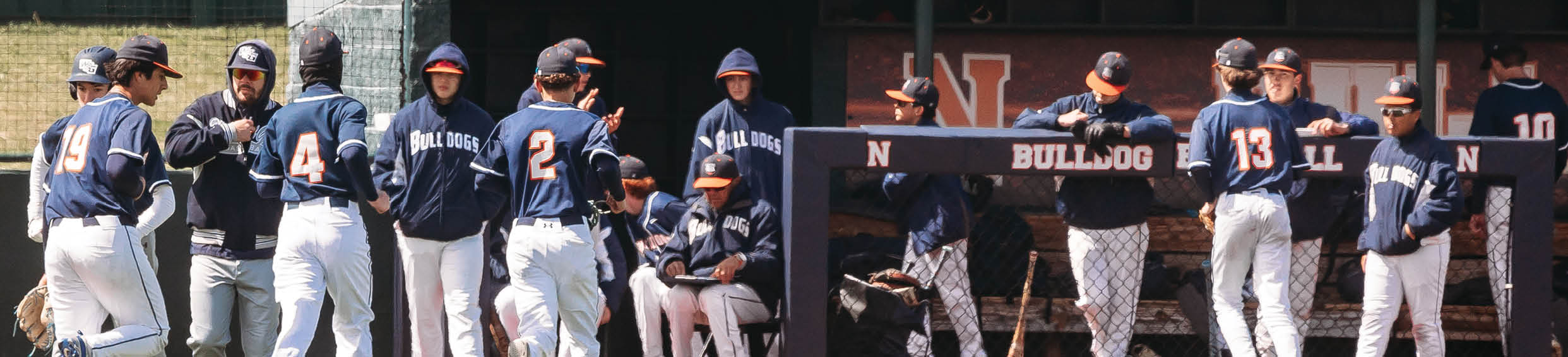 A group of baseball players are standing on the field, some of them wearing blue uniforms. Contenido generado con IA