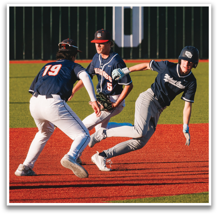 Three baseball players on a field, one of them sliding into a base. Contenido generado con IA