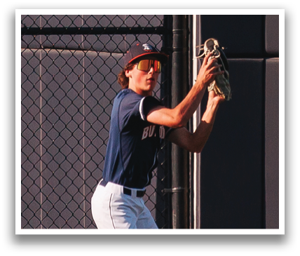 A baseball player in a blue shirt and white pants catching a ball. Contenido generado con IA