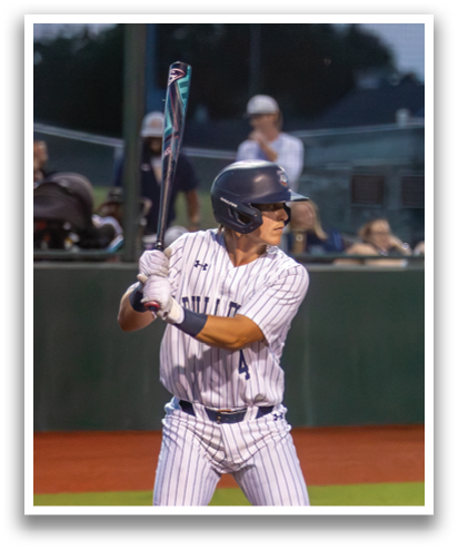 A baseball player in a blue and white uniform is swinging a bat at a ball. Contenido generado con IA