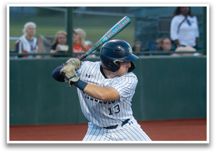 A baseball player is swinging a bat at a ball during a game. Contenido generado con IA