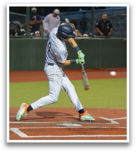 A baseball player in a blue and white uniform is swinging a bat at a ball. Contenido generado con IA