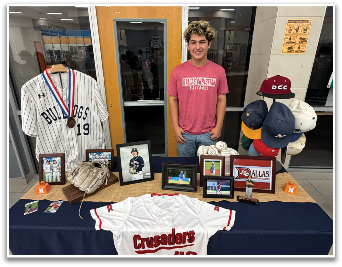 A young man stands in front of a table with a baseball jersey on it. Contenido generado con IA