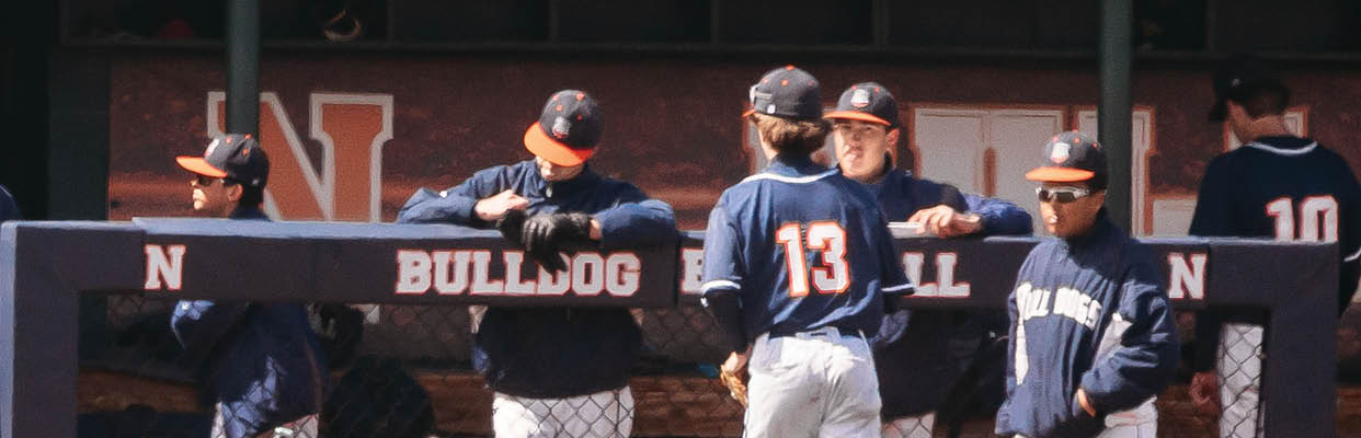 A group of baseball players are standing on the field, some of them wearing blue uniforms. Contenido generado con IA