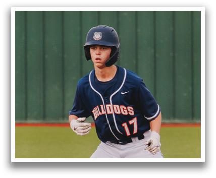 A baseball player wearing a blue uniform and a blue helmet is standing on the field. Contenido generado con IA