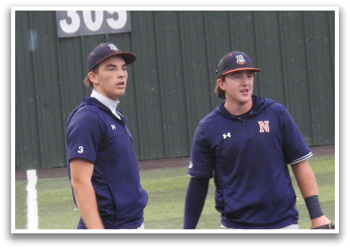 Two baseball players wearing blue and grey uniforms stand on the field. Contenido generado con IA