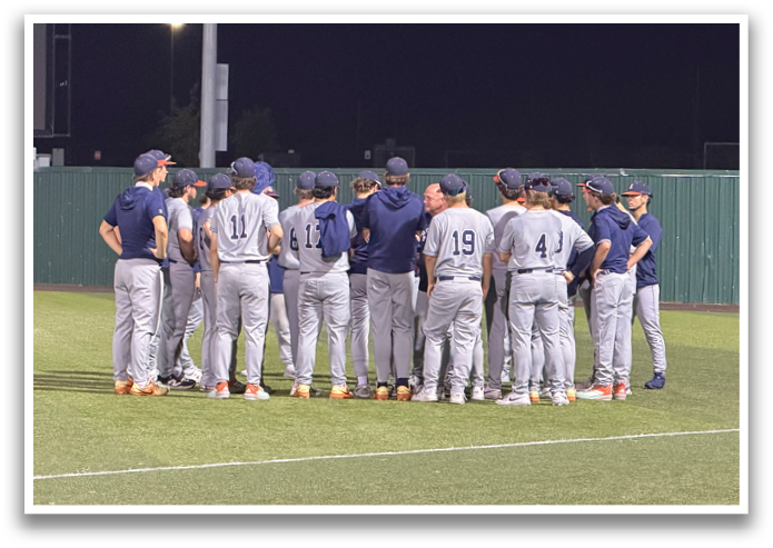 A group of baseball players wearing blue and grey uniforms are standing on a field. Contenido generado con IA