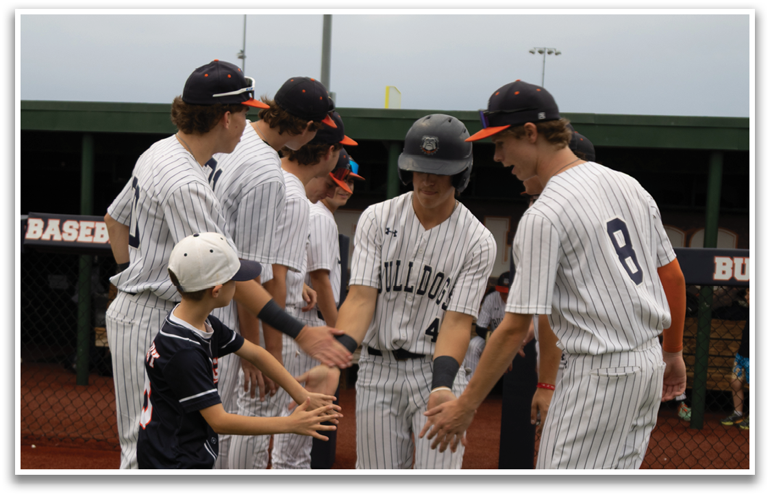 A group of baseball players shake hands with a young boy on the field. Contenido generado con IA