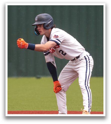 A baseball player wearing a helmet and orange gloves is standing on a base. Contenido generado con IA
