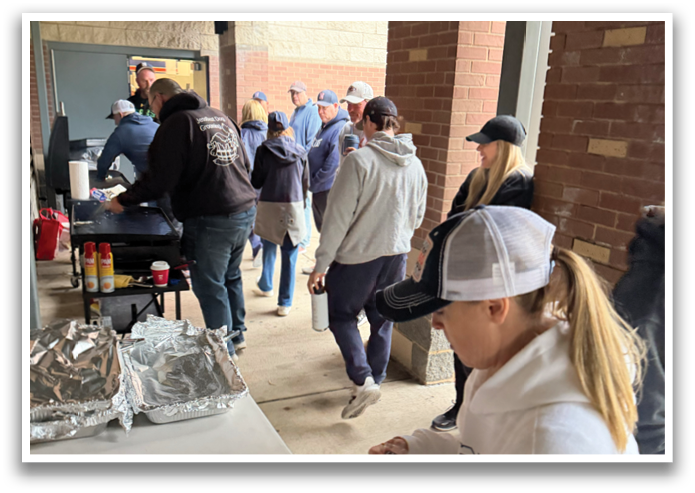 A group of people are gathered around a table with a grill on it. Contenido generado con IA
