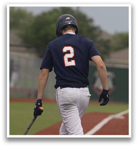 A baseball player wearing a blue shirt and white pants is holding a bat and walking towards home plate. Contenido generado con IA