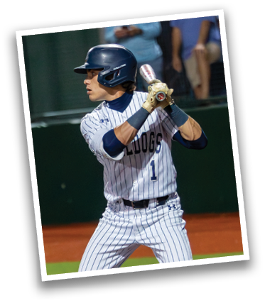 A baseball player in a blue helmet and striped uniform is holding a bat, ready to swing. Contenido generado con IA