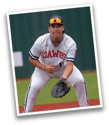 A baseball player in a white uniform is crouching on the field, wearing a glove and ready to catch a ball. Contenido generado con IA