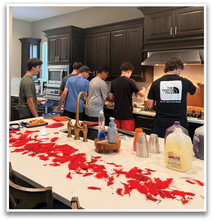 A group of people are standing around a kitchen counter with various items on it, including a bottle of wine. Contenido generado con IA