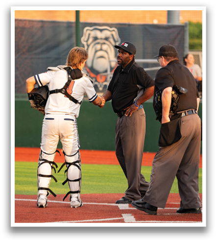 A baseball player is shaking hands with an umpire and another official on the field. Contenido generado con IA