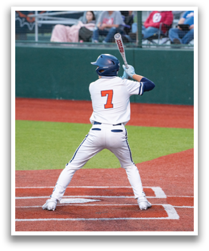 A baseball player is at bat, holding a bat and preparing to swing. The catcher is ready to catch the ball. Contenido generado con IA