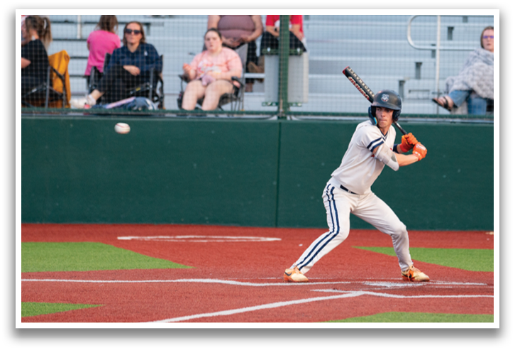 A baseball player is swinging a bat at a ball during a game. Contenido generado con IA