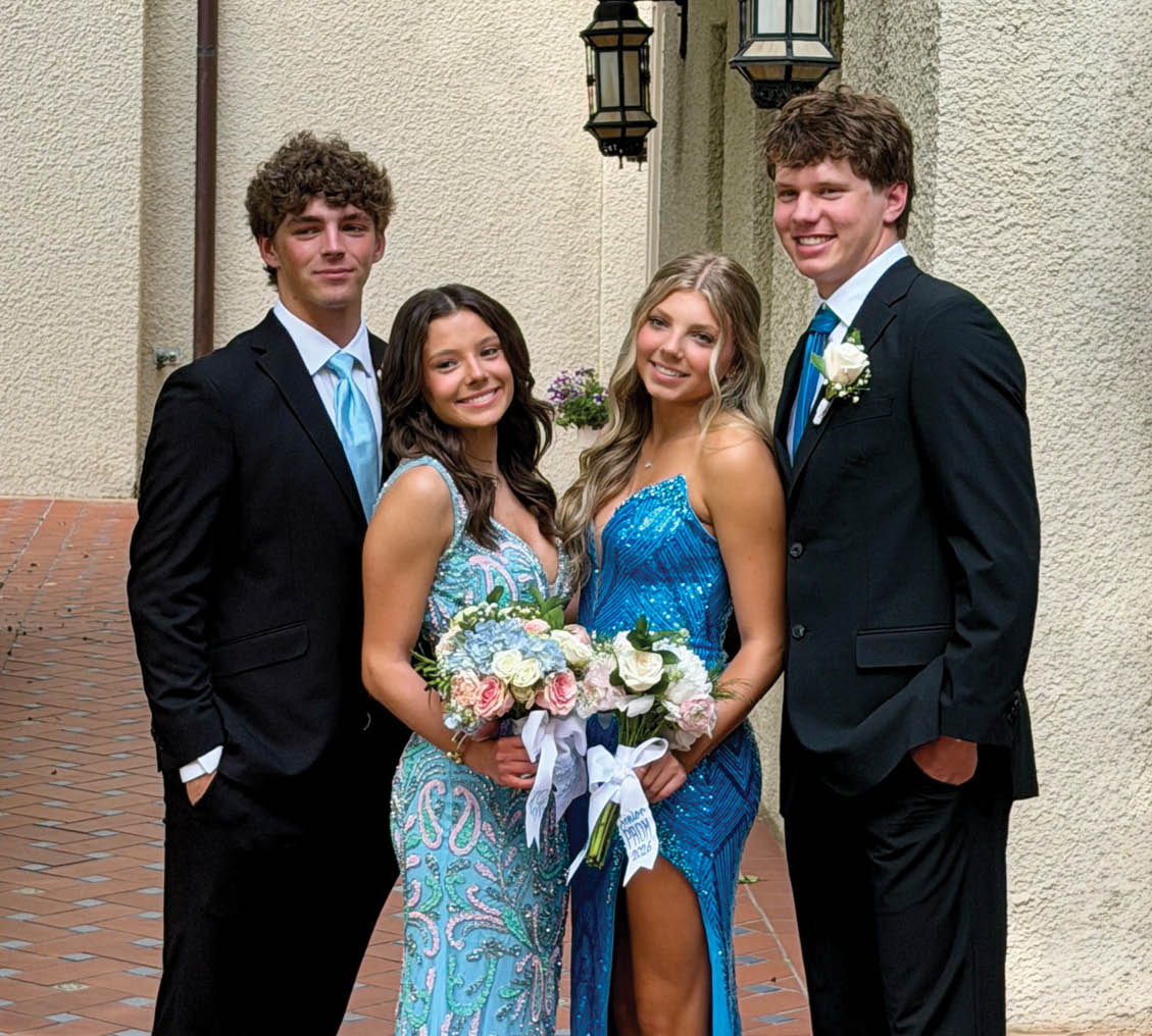 Four young men in suits and ties pose for a picture. Contenido generado con IA