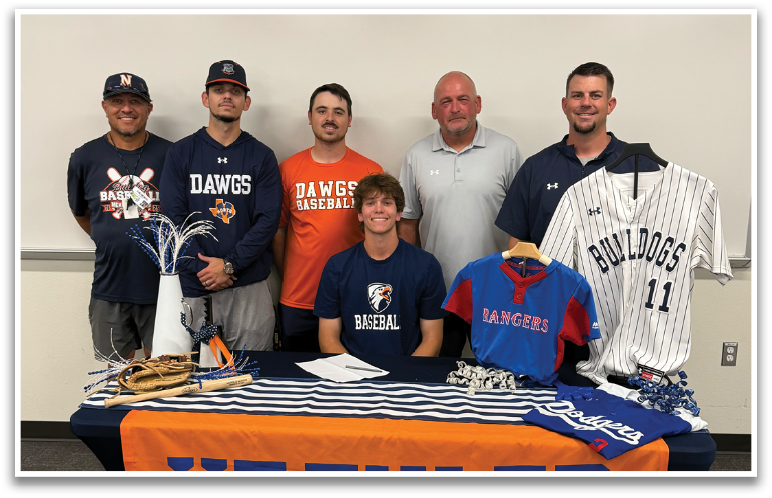 A group of people are standing in front of a table with a baseball jersey on it. Contenido generado con IA