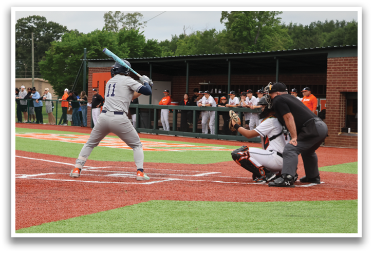 A baseball player is swinging a bat at a ball during a game. Contenido generado con IA