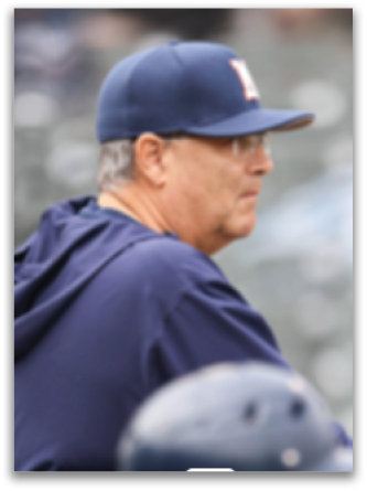 A baseball player wearing a blue hat and a blue jacket. Contenido generado con IA
