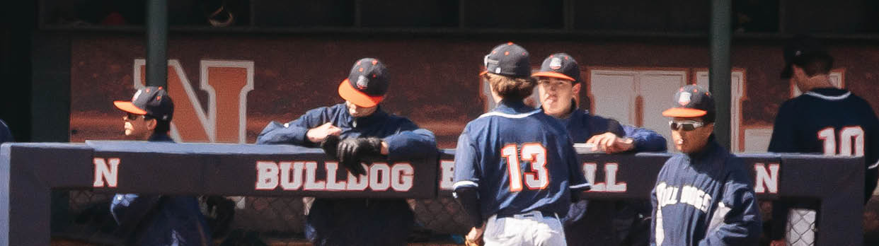 A group of baseball players are standing on the field, some of them wearing blue uniforms. Contenido generado con IA