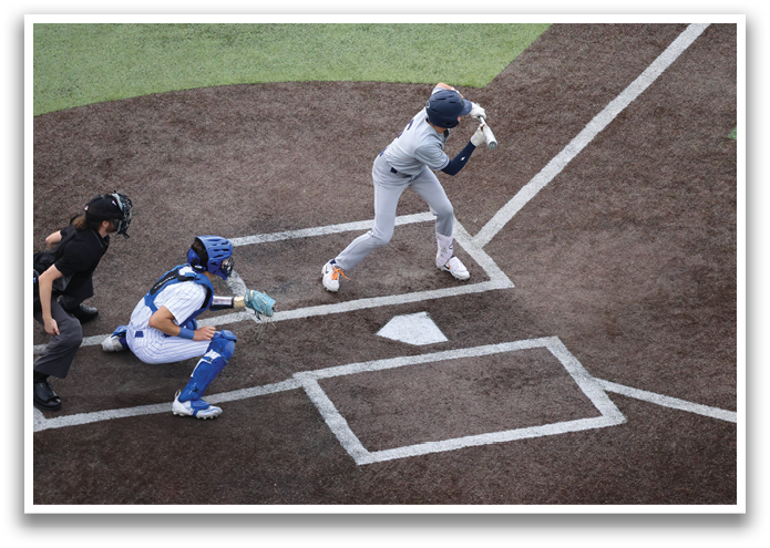 A baseball player is swinging a bat at a ball. Contenido generado con IA