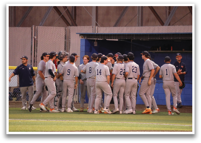 A group of baseball players in uniforms huddle together on the field. Contenido generado con IA