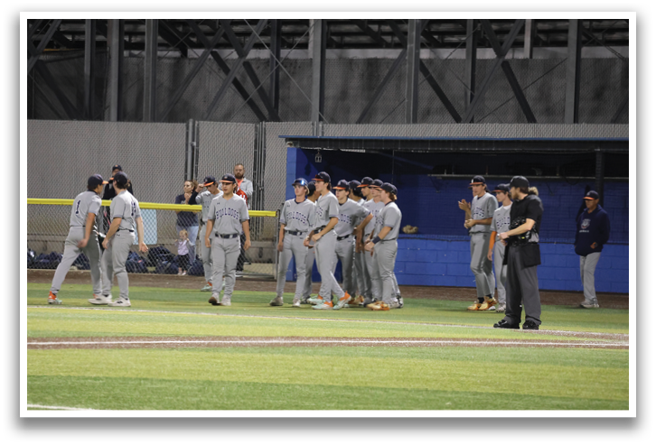 A group of baseball players are standing on a field, some of them wearing baseball gloves. Contenido generado con IA