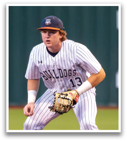 A baseball player in a striped uniform is standing on the field, ready to catch a ball. Contenido generado con IA