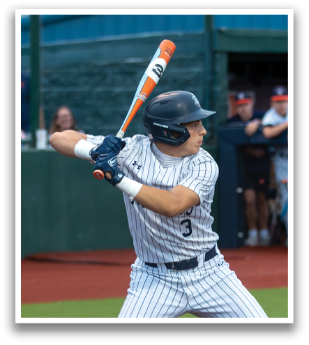 A baseball player in a blue and white uniform is swinging a bat at a ball. Contenido generado con IA