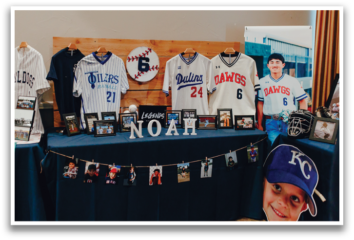 A table with a baseball jersey on it and a boy with a baseball hat on. Contenido generado con IA