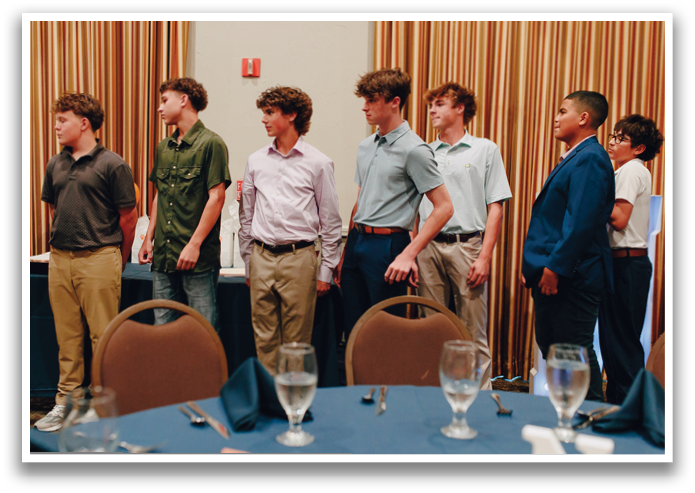 A group of young men are standing in a row, wearing dress shirts and ties. Contenido generado con IA