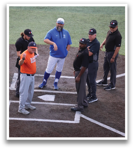 A group of men, including an umpire, are standing on a baseball field. Contenido generado con IA