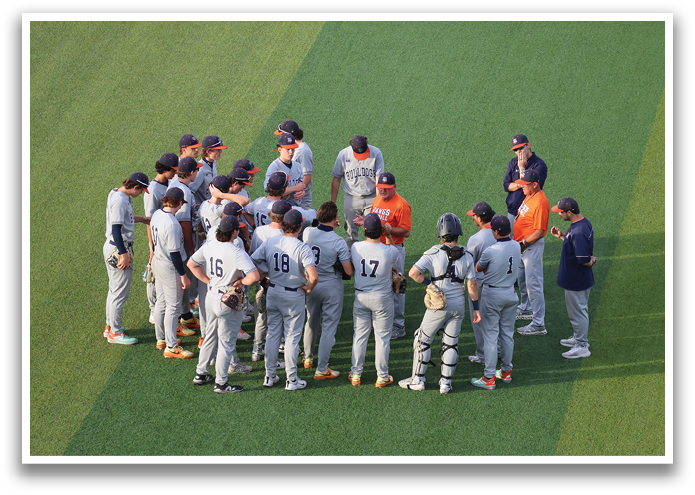 A group of baseball players huddled together on a field. Contenido generado con IA