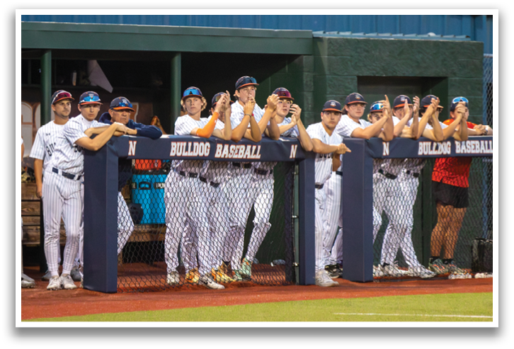 Baseball players in uniforms are standing on a field, some of them wearing sunglasses. Contenido generado con IA