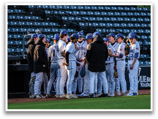 A group of baseball players wearing blue hats and white uniforms are standing together on a field. AI generated content